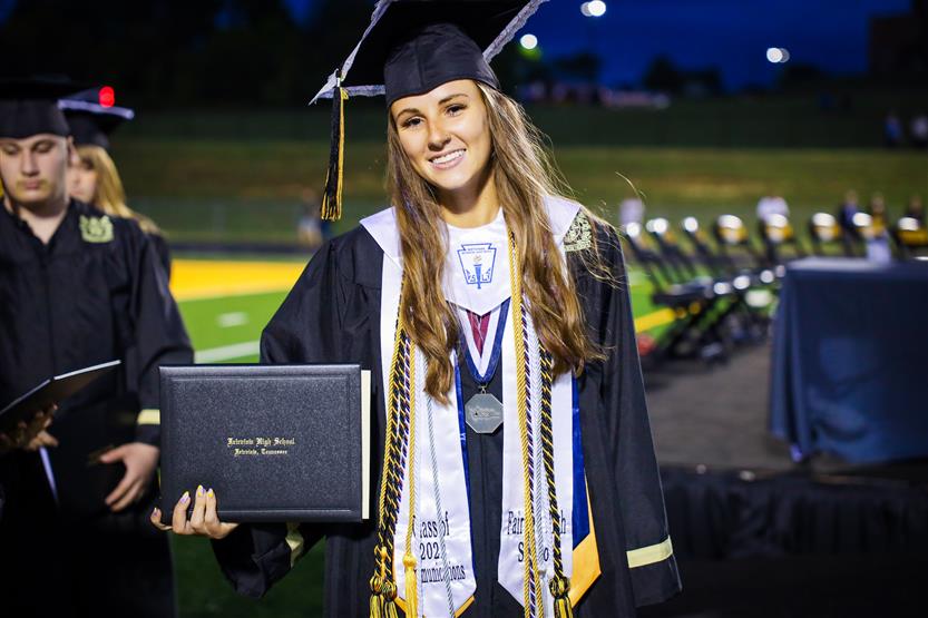 Students graduate on a football field